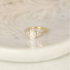 a diamond ring sitting on top of a white plate