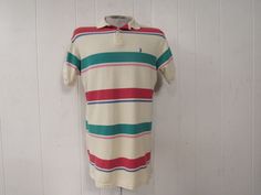 "Vintage 1980s or 90s color block striped cotton polo shirt. Made in the U.S.A. by Polo Ralph Lauren. Has embroidered Polo horse and jockey on chest. Size medium. Actual measurements are: 43\" at the chest 42\" at the waist 18.5\" shoulder seam to shoulder seam 31\" overall length In very good condition." Cotton Polo Shirt With Vertical Stripes, Cotton Short Sleeve Polo Shirt With Vertical Stripes, Cotton Polo Shirt With Vertical Stripes For Summer, Summer Cotton Polo Shirt With Vertical Stripes, Casual Striped Polo Shirt, Casual Multicolor Polo Shirt With Striped Collar, Multicolor Cotton Polo Shirt With Striped Collar, Retro Striped Polo Shirt, Retro Cotton Polo Shirt With Striped Collar