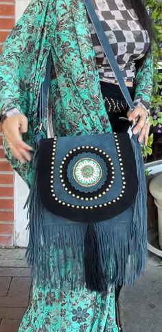 Suede long fringe teal messenger bag. Leather Beaded Fringe Purse Each bag is unique and totally one of a kind! Room enough for all your daily essentials, this purse matches any bohemian style outfit and more. Featuring tassel and bead details, and so much fun fringe! Approx. 12" x 10" x 3.5" Zipper closure, 1 inside zipper pocket View this post on Instagram A post shared by Pink House Boutique (@pinkhouseboutique) Bohemian Shoulder Bag With Fringe For Travel, Bohemian Festival Bags With Beaded Fringe, Turquoise Bags For Festivals, Bohemian Turquoise Bags For Festival, Bohemian Bags With Beaded Fringe For Everyday Use, Artisan Fringe Shoulder Bag For Festival, Artisan Shoulder Bag With Fringe For Festivals, Artisan Bags With Tassels For Festivals, Bohemian Turquoise Shoulder Bag