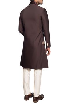 Designed exquisitely in the comfort wear slim fit silhouette, this brown toned sherwani is ornated with delicate embroidery across the collar. The ensemble lends an upscale modern feel to your look for the occasional function. It is paired with off-white cotton silk kurta and completed with the trouser.
Set of 3
Zardozi Embroidery
Fancy Metal Button Fastening
Chest Welt Pocket - Aza Fashions Embroidered Sherwani, Zardozi Embroidery, Silk Kurta, Delicate Embroidery, Comfort Wear, Metal Buttons, Cotton Silk, Aza Fashion, Welt Pocket