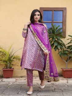 With festivals around the corner, wardrobe update is mandatory. Presenting brocades like never before. Made in straight silhouette with narrow pants and organza dupatta, which is beautified with lovely hand work. Taari and gotta detailing on dupatta is just the right touch. Color: Purple Fabric: Kurta & Bottom- Brocade Dupatta - Organza Note: Length and sizes can be customised Length - Kurta 40 inches Pants 38 inches Available in other colors If you happen to see some deformity in hand-work or f Purple Palazzo Set With Dabka Work And Straight Kurta, Festive Purple Kurta With Dabka Detail, Brocade Suit Design, Purple Brocade Set With Dupatta, Purple Bollywood Brocade Sets, Wedding Brocade Purple Dupatta, Brocade Dupatta, Banarsi Suit, Brocade Kurta