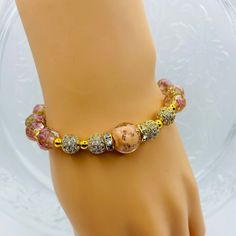 Elevate your style with these stunning bracelets for women, featuring luxurious 18k gold plated hematite beads paired with delicate pink lampwork glass beads and sparkling CZ inlaid spacer beads. The perfect gift for her, these bracelets combines elegance with a touch of glamour. Make a statement with these unique and eye-catching accessories that are sure to turn heads wherever you go. Handcrafted with care and attention to detail, they are sure to become a favorite accessory in any jewelry col Elegant Adjustable Stretch Bracelet With Colorful Beads, Adjustable Gold Beaded Bracelets With Gemstone, Gold Charm Bracelet With Colorful Beads For Jewelry Making, Adjustable Gold Jewelry With Colorful Beads, Elegant Stretch Bangle Bracelet With Colorful Beads, Elegant Crystal Bracelet With 8mm Beads, Gold Bangle With Colorful Beads, Adjustable Gold Bracelets With Colorful Beads, Elegant Adjustable Colorful Beaded Bracelets