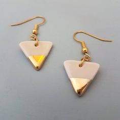 A pair of small pink glazed porcelain triangle dangle earrings with 22k gold lustre detail. Ear posts are gold plated hypoallergenic fish hooks for pierced ears. They will be supplied with clear rubber stoppers.The porcelain triangles are fired 3 times to achieve this finish and are very lightweight and durable. Please note the earrings are only glazed on one side due to the nature of the process. The back will be the pure white of the porcelain.The triangles measure approx 1.5 cm wide x 1.5 cm Triangle Shaped White Jewelry For Gifts, White Triangle Jewelry Gift, White Triangle Jewelry For Gift, White Triangle Earrings For Gift, Gold Heart Studs, Triangle Earrings Stud, Gold Triangle, Triangle Studs, Fish Hooks