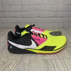 Introducing The Nike Rival Waffle 6 Cross Country Shoes In Men's Size 11. This Pair Features A Vibrant Color Combination Of Volt Hyper Pink, Making It A Great Choice For Those Who Love Colorful And Stylish Racing Footwear. The Shoes Are Designed With A Low Top Shoe Shaft Style And Lace-Up Closure For A Comfortable And Secure Fit. The Nike Waffle 6.0 Model Is A Lightweight And Breathable Sneaker That Is Perfect For Racing And Running Activities. It Is Made Of Synthetic Upper Material And Has Stan Nike Running Shoes With Rubber Waffle Outsoles For Sports, Nike Running Shoes With Durable Outsoles For Sports, Yellow Running Shoes With Rubber Waffle Outsoles For Sports, Nike Sports Running Shoes With Vibram Sole, Sporty Running Shoes With Rubber Waffle Outsoles For Training, Nike Yellow Running Shoes For Trail, Yellow Running Shoes With Rubber Waffle Outsoles, Nike Running Shoes With Vibram Sole For Training, Nike Running Shoes For Training With Rubber Sole