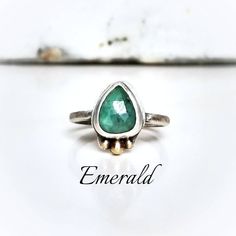 "Genuine 10mm faceted green emerald is handset in oxidized sterling silver with recycled 14k gold mixed metal accents. ~Ring with stone set is a size 7 (can be hammered to 7.25\") ~If you need a different size please choose loose stone and I will create your own custom ring ~Wrapped in black gift box ~Handmade in Tennessee" Unique Emerald Birthstone Jewelry, Unique Green Everyday Jewelry, Unique Emerald Ring For May Birthstone, Heirloom Emerald Ring With Bezel Setting For May Birthstone, Heirloom Emerald Ring With Bezel Setting, Unique Sterling Silver Emerald Birthstone Ring, Unique Sterling Silver Emerald Ring For May Birthstone, Everyday Jewelry With Bezel Setting For May Birthstone, Faceted Emerald Ring For Anniversary