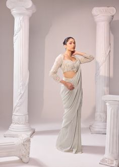 An exquisit Italian imported fabric being the key highlight of this ensemble which is sure to never go out of trend. An artistic symphony of fine aari embroidery adorns the blouse with full sleeves. It has 3D katdana loops, this unreal detailing enhance the ethreal look of the outfit. Colour: Glacier Gray Material: Italian - Saree, Organza- Blouse No of components: 2 Surface Ornamentation: Hand Embroidery Care Instructions: Dry Clean Shipping Time: 3-4 weeks Blouse With Full Sleeves, Surface Ornamentation, Saree Organza, Shirt Jacket Men, Organza Blouse, Drape Saree, Aari Embroidery, Silk Roses, The Outfit