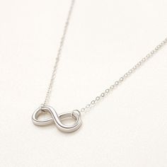 These beautiful necklaces will make the day of the most demanding sights! Carefully crafted with high-quality 925 Rhodium Plated Silver, bearing a beautiful design, these exclusive necklaces from our new collection will become a great present for your loved ones. The sterling silver infinity symbol pendant represents endless love and connection, making it a thoughtful gift or a meaningful addition to your own jewelry collection. Product Details: Metal: Sterling Silver Base Metal Purity: 925 Plat Dainty Silver Infinity Necklace, Silver Infinity Jewelry, Silver Dainty Infinity Necklace, Silver Infinity Dainty Necklace, Silver Infinity Clavicle Chain Jewelry, Sterling Silver Infinity Necklace With Adjustable Chain, Silver Infinity Necklace In Dainty Style, Sterling Silver Infinity Necklace In White Gold, Silver Infinity Clavicle Chain Necklace