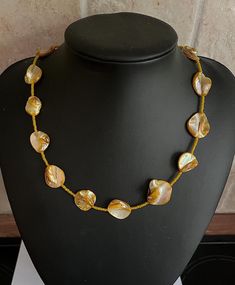 This is a beautiful shell necklace made with dyed yellow mother of pearl shell beads interspaced with smaller yellow glass beads. This is an unusual and stunning necklace which is perfect for the summer to show off that tan or as a gift for any lover of yellow!  The length of the necklace is a touch over 18 inches measuring 47 cm. The necklace fastens by way of a lobster clasp and ring.  The necklace comes presented and wrapped in a pink Sugar and Spice gift box making it perfect for gifting 💛 Handmade Gold Shell Necklace, Handmade Gold Shell-shaped Necklace, Gold Handmade Shell-shaped Necklace, Gold Beaded Shell, Yellow Pearl Necklaces With Round Beads, Handmade Yellow Pearl Necklaces, Yellow Beaded Pearl Necklace Gift, Yellow Beaded Pearl Necklace As Gift, Gold Shell Necklace Made Of Mother Of Pearl