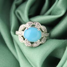 Presenting you a Beautiful Blue Chalcedony Ring accented with Oval Cabochon Shape Blue Chalcedony in a classical four-prong setting along with two layers of side accented Cubic Zircon with grains embossed on edges to keep the vintage feel. The Gems used have an Aqua Blue Color Perfect Promise or Proposal Ring, Anniversary Gift or a Promise Ring Item No: skj. 19.505 Item: Blue Chalcedony In 925 Silver Ring (Can Be personalized) Primary Stone: Blue Chalcedony Secondary Stone:-- Article Weight: 5.1 gms primary stone Size: 10x8 mm Ring Length: 2cm Ring Width: 1.3 cm Maintenance Tips 1. Keep the jewelry away from direct heat, water, perfumes, deodorants, and other strong chemicals.  2. Wipe the Jewellery gently with a chamois cloth or leather swatch after every use.  3. Wiping the jewelry with Blue Chalcedony Ring, Aqua Blue Color, Layered Rings, Chalcedony Ring, Aqua Chalcedony, 925 Silver Ring, Proposal Ring, Classic Jewelry, Blue Chalcedony