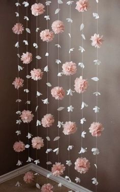 pink and white flowers hanging from the ceiling