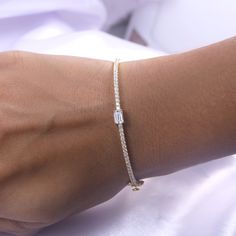 Add a touch of elegance to any outfit with our Emerald & Round White Cubic Zirconia Tennis Bangle Bracelet. Crafted from 925 sterling silver, this bracelet exudes sophistication and luxury. The perfect accessory for the refined woman, it combines the classic tennis bracelet design with a modern twist, featuring vibrant emerald and sparkling round white cubic zirconia stones. Elevate your style with this exquisite piece.Model No : CSBN11223-CZ Elegant Sparkling Diamond Bracelet As Gift, Elegant Cubic Zirconia Bracelets As Gift, Elegant Cubic Zirconia Bracelets For Gifts, Elegant Diamond Bracelet With Sparkling Stones As Gift, Elegant Cubic Zirconia Bracelet Gift, Dainty Cubic Zirconia Diamond Bangle Bracelet, Adjustable Classic Gold Bracelet With Cubic Zirconia, Elegant Cubic Zirconia Gold Bracelet For Gift, Fine Jewelry Sparkling Bracelet For Anniversary