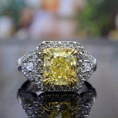 This stunning diamond ring creates a lasting impression through its colorful demeanor. The center stone is a luxurious 2.00 carat radiant cut, fancy yellow diamond. This impressive diamond glows with a beautiful color hue along side its fiery attributes for a glorious effect. Metal : 14k Gold, 18k Gold, or Platinum Setting Type : U-Pave, Bezel, Prong Total Carat Weight : 3.26 Carats Type : Natural Genuine Diamond Shape : Radiant Cut Carat Weight : 2.00 Ct.( GIA Certified) Cut : Excellent Color : Classic Yellow Gia Certified Jewelry, Formal Yellow Cushion Cut Diamond Ring, Yellow Radiant Cut Diamond Wedding Ring, Yellow Cushion Cut Diamond Jewelry, Yellow Cushion Cut Gemstone Ring, Dazzling Yellow Jewelry With Vvs Clarity, Yellow Diamond Ring With Cushion Cut, Yellow Cushion Cut Diamond Ring With Center Stone, Yellow Diamond Ring With Vvs Clarity As A Gift