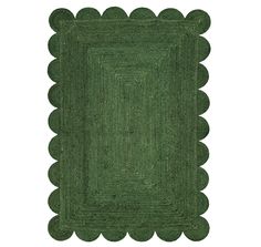 a green rug with scalloped edges on the bottom and an oval design in the middle