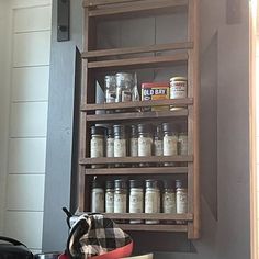 a wooden shelf filled with lots of jars