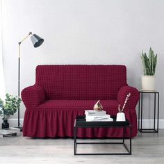 a living room with a red couch and coffee table