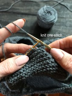 two hands holding knitting needles over a piece of yarn