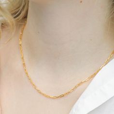 This timeless chain link necklace is sure to become a go-to jewelry staple when you want to add a touch of glam to your look. Plated in 16K genuine gold or silver, this delicate paper clip chain necklace is stunningly designed, and is perfect for anyone to wear. Wear this necklace alone or pair it with other dainty necklaces and pendants for a layered look. Materials & Dimensions METAL: 16k genuine gold or silver-plated brass SIZE: 17" / 19'' chain; Chain width: 2mm CLOSURE: Lobster claw Avoid c Elegant Gold Plated Paperclip Chain Bracelet, Minimalist Paperclip Chain Necklace As Gift, Minimalist Paperclip Chain Necklace For Gift, Minimalist Paperclip Chain Necklace Gift, Figaro Chain Necklace With Rectangular Links As Gift, Paperclip Necklace With Delicate Chain For Gift, Gift Figaro Chain Necklace With Rectangular Links, Dainty Paperclip Chain Necklace For Gift, Elegant Link Paperclip Bracelet With Delicate Chain