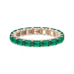 This eternity ring showcases a stunning balance between vintage glamour and feminine romance. It features emerald-cut created Emerald in an east-west setting evoking Art Deco's architectural splendor. Each emerald-cut diamond is set on a thick U-shaped prong punctuated by a pair of petite round diamonds on its side. The curved yellow gold prongs form a circle and makeup the graceful, scalloped base of the band. Luxury Stackable Emerald Cut Emerald Ring, Luxury Stackable Emerald-cut Emerald Ring, Luxury Emerald Ring With Rectangular Stone, Luxury Emerald Ring With Rectangular Stone For Wedding, Luxury Rectangular Emerald Wedding Ring, Gorgeous Engagement Ring, Emerald Gemstone, Emerald Cut Diamonds, Vintage Glamour