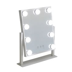 a white lighted vanity mirror sitting on top of a table