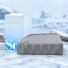 a box sitting on top of a snow covered ground next to a bed in the snow