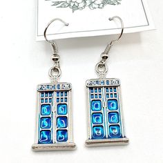 Handmade Earrings Style: Dr Who Tardis (Flat Design) Comes With Organza Bag New Makes A Great Gift For Any Occasion Or Holiday! Don't Forget To Check Out My Other Styles! Keywords: Doctor Who, Tardis, Policebox, British, Bbc, Dr Who, David Tennent, Present, Hanging, Earring, Drop, Birthday, Gift, Handmade, Made In Usa, Nj Artist, Female Owned, Artisan, Craft Blue Metal Earrings For Gift, Cadmium-free Blue Earrings As Gift, Blue Rectangular Earrings With Ear Wire, Blue Dangle Earrings Cadmium-free, Blue Rectangular Earrings, Blue Cadmium-free Drop Earrings, Nickel Free Blue Rectangular Jewelry, Tardis Blue Dress, Doctor Who Earrings