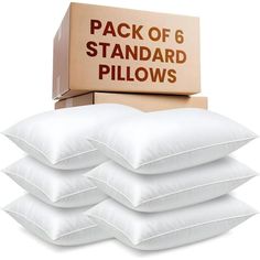 the pack of 6 standard pillows is in front of a cardboard box and on top of it