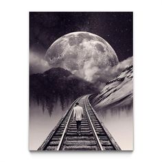 a man walking on train tracks towards the moon