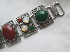 Beautiful vintage 1940s silver tone wide 5 link bracelet with gemstones, opal, jade, carnelian and amethyst in good vintage condition and measures 7 inches long by 1 1/4 inches wide. Vintage Multicolor Stone Bracelets, Vintage Silver Gemstone Bracelets, Vintage Silver Bracelets With Gemstones, Vintage Stone Bracelets As Gift, Vintage Stone Bracelet For Gift, Vintage Natural Stones Gemstones For Gift, Vintage Natural Stones Gemstones As Gift, Vintage Natural Stones Gemstones, Vintage Round Natural Gemstones