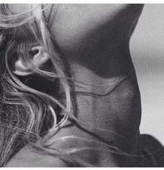 the back of a woman's head with her hair blowing in the wind, black and white photograph