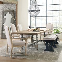 a dining room table with chairs and a bench