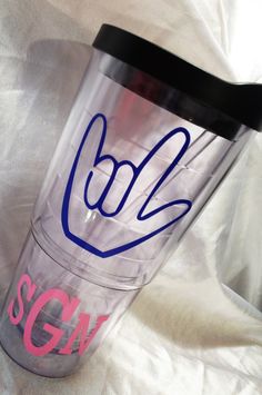 a tumbler cup with the word bl2 on it is sitting on a white sheet