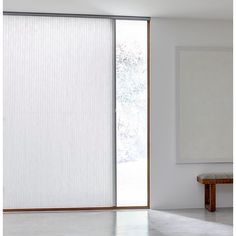 an open sliding glass door with white blinds on the outside and wood trimmings