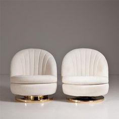 two white chairs sitting next to each other