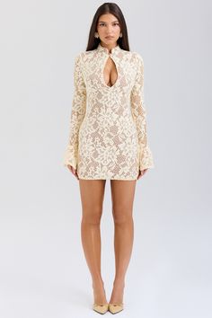 DESCRIPTION: The dress is our beautifully feminine mini dress in a delicate floral lace. This enchanting design features a high neck and a peek-a-boo keyhole front. It has a bodycon silhouette for a snatching fit. enhanced by the inner mesh layer that also works well for the perfect coverage. The long sleeves have pretty fluted cuffs and it zips to the side for easy on. For the most elegant look. pair yours with vertiginous tonal heels.  WHERE TO WEAR: Pretty date nights. romantic dinner dates. Scalloped Lace Mini Dress For Date Night, Fitted Mini Length Crochet Dress With Scalloped Lace, Fitted Crochet Dress With Scalloped Lace, Mini Length, Fitted Crochet Mini Dress With Scalloped Lace, Beige Lace Mini Dress With Patchwork, Beige Lace Mini Dress With Lace Patchwork, High Neck Lace Dress With Lace Trim, Feminine Mini Crochet Dress With Lace Trim, Mini Lace Dress With Scalloped Lace For Date Night