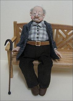 an old man sitting on top of a wooden bench next to a cane and hat