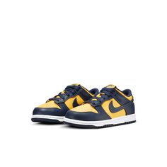 The Nike Dunk Low PS 'Michigan' 2021 is a retro hoops shoe that pays homage to the Michigan Wolverines. It features a simple two-tone design in Varsity Maize and Midnight Navy, with standard Nike branding on the tongue tag and heel tab. The all-leather upper sits atop a contrasting white midsole, making it the perfect shoe for little kids who love the Wolverines. Dunk Lows, Maize And Blue, Red Puffer, Yellow Nikes, Nike Branding, Football Program, University Of Michigan, Nike Kids, Michigan Wolverines