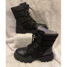 The Amita Hiker Booties From Marc Fisher Have An Exaggerated Lug Sole, Puffed Nylon Upper And Lace Up Detailing That Perfectly Tie Together Any Cool-Weather Ensemble. Heel Height - 2.17" Shaft Height - 5.71", Calf Circumference - 9.84" Shoe Width - Medium Zipper Closure Faux Leather Upper, Textile And Manmade Lining, Manmade And Leather Sole Round Toe Faux Leather Spot Clean Imported Black Lace-up Boots With Padded Ankle And Round Toe, Black Combat Boots With Reinforced Heel For Outdoor, Black Moto Boots With Padded High Ankle, Black Mid-calf Boots With Lug Sole And Medium Width, Black Ankle Combat Boots With Reinforced Heel, Black Combat Boots With Reinforced Heel For Winter, Winter Combat Boots With Lug Sole And Closed Toe, Winter Combat Boots With Rubber Sole, Black Ankle Lace-up Boots With Lug Sole