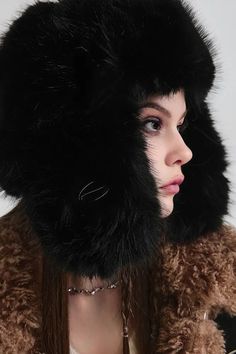 Plush Elegance for Winter Warmth Indulge in the luxurious comfort of our Fluffy Faux Fur Ushanka Hat. Expertly crafted for the autumn and winter seasons, this hat marries fashion with function. Made from high-quality, plush materials, it offers unmatched warmth and elegance. The innovative design provides full ear coverage, ensuring comfort in the harshest of winters. The adjustable strap and soft lining cater to all-day wear, making it a versatile choice for both casual strolls and chic outdoor Black Faux Fur Hat For Fall, Elegant Winter Beanie Hat, Faux Fur Winter Hat With Ear Flaps, Winter Faux Fur Hats With Ear Flaps, Warm Faux Fur Hats With Ear Flaps, Winter Black Sheepskin Hats, Winter Hats With Faux Fur Trim And Ear Flaps, Winter Hats With Faux Fur Trim, Winter Hat With Feather Trim