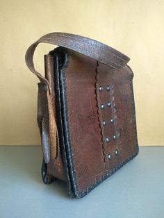 Vintage Bag Of Genuine Calfskin - Retro leather bag - Old leather bag from 60' - brown leather bag - Genuine Leather Bag - Shoulder bag The old bag has traces of use. Dimensions : The length of the handle / strap / - 58 centimeters 22 cm x 23 cm x 7 cm For other vintage bag check here : https://www.etsy.com/shop/TheVINTAGEShopBG?ref=l2-shop-info-name&section_id=22456024 FAST SHIPPING ! Possible express delivery with DHL but please first ask me for price . All pictures are real . You buy exac Brown Leather-handled Crossbody Box Bag, Distressed Brown Leather-lined Satchel Shoulder Bag, Brown Soft Leather Shoulder Box Bag, Brown Leather Crossbody Briefcase, Brown Rectangular Shoulder Bag With Leather Handles, Brown Textured Leather Bag For Daily Use, Cognac Textured Leather Satchel Shoulder Bag, Brown Soft Leather Square Shoulder Bag, Cognac Textured Leather Rectangular Bag