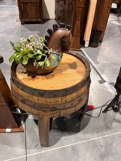 a wooden table with a potted plant sitting on it's top in a store