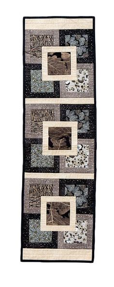 a black and white quilt with several pictures on the front, one is made out of fabric