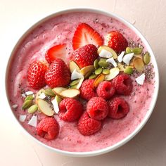 a bowl filled with fruit and nuts on top of a table