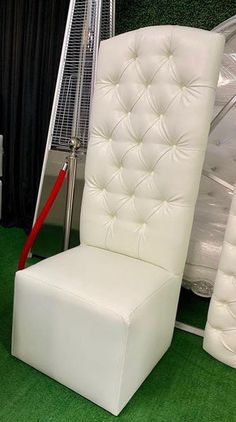 a white chair sitting on top of a green carpet