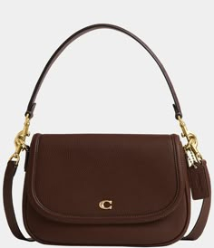 From COACH&#x2C; the Legacy Small Pebbled Leather Shoulder Bag features: Featuring a COACH logo flap&#x2C; this Legacy shoulder bag sits just beneath the underarm with the shorter strap or it can be worn as a crossbody. Small-sized bag; 10" W x 7.25" H x 2.75" D (width is measured across the bottom of handbag); 1.32 lbs. approx. weightApprox. 7.5" L removable short strap; 21.5" L removable crossbo Coach Brown Purse, Classic Coach Bags, Small Brown Shoulder Bag, Coach Small Purse, Brooklyn Shoulder Bag, Brown Coach Shoulder Bag, Staple Designer Bags, Everyday Designer Handbags, Small Coach Purse