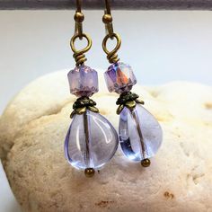 Enchanting lavender Czech glass teardrop earrings for an understated elegant look. Small iridescent beads top off lavender teardrops, adding just the right amount of sparkle. These cottagecore earrings make a stunning addition to any jewelry collection. Lavender is a versatile color, trending now. Beautiful with purple, green, pink, yellow, and more colors. Free gift packaging included. Earrings are carded and in an organza bag. Hypoallergenic ear wires (nickel and lead free). Select ear wire st Light Purple Earrings, Prom Jewelry Earrings, Earrings 2024, Jewelry Trending, Cottagecore Earrings, Lavender Earrings, Reno Nv, Prom Jewelry, Purple Earrings