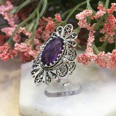 925 Sterling Silver Genuine Purple Amethyst Artisan Crafted Filigree Cocktail Statement Ring Women Jewelry Gift Boxed Material: 925 Solid Sterling Silver Genuine Purple Amethyst Gemstone Dimensions : 14 mm x 7 mm, Approximate Total Carat Weight: 3.4 Ring Face Length: 1. 4 inches Width: 0.88 inches Nickel free This will come in a designer pouch & gift box with a romance card Free Domestic Shipping It is a gift that will create memories for years to come. Our fine silver jewelry is Made in our Sterling Silver Purple Jewelry With Intricate Design, Sterling Silver Amethyst Ring Gift, Fine Jewelry Sterling Silver Amethyst Ring For Gift, Silver Amethyst Ring With Accent Stones As Gift, Purple Sterling Silver Jewelry With Intricate Design, Sterling Silver Jewelry With Intricate Design In Purple, Purple Amethyst Ring With Filigree, Silver Sterling Silver Amethyst Ring Gift, Sterling Silver Amethyst Ring With Accent Stones As Gift