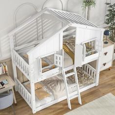 a white bunk bed with two sets of stairs and a desk in the corner next to it