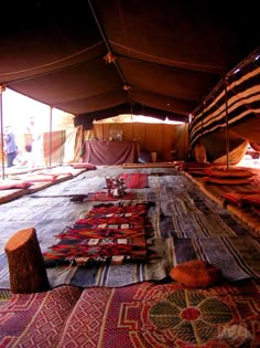 many rugs are laid out on the ground