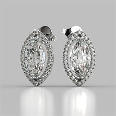 Dress up your attire with this posh set of earrings. Vibrant center stones are featured within a stunning simulated diamond pave halo. An optimal choice for your ensemble.    Marquise Cut Drop Style Stud Earrings;  Center Stone: 2CT Each;  Total Carat Weight: 4.42CTW;  Stone Clarity: VVS-1;  Available in: 14K White Gold;  Model:ER2508-WH; Round Diamond Stud Earrings, Diamond Stud Earring, Diamond Earrings Studs Round, White Gold Studs, White Gold Earrings Studs, Round Halo, Best Engagement Rings, Halo Earrings Studs, Gold Models