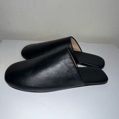 Butter Soft All Leather New Without Box Mules Classic Black Mules With Leather Sole, Black Calf Leather Loafers With Leather Footbed, Black Leather Slip-on Mules, Sleek Closed Toe Mules With Leather Sole, Classic Black Mules With Rubber Sole, Sleek Closed Toe Mules With Removable Insole, Chic Black Slip-on Slippers, Chic Closed Toe Slippers With Leather Sole, Sleek Mules With Leather Sole And Round Toe